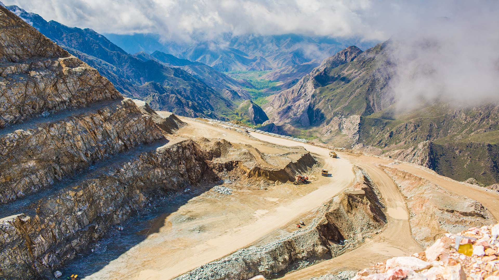 Drone style view of East Region mining facilities. A body of water can be seen in the distance. 