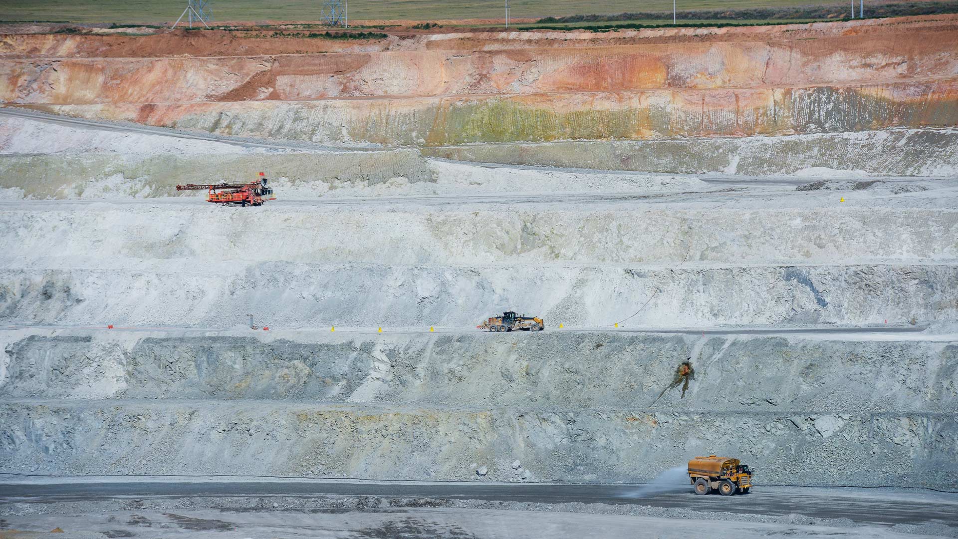 Red, blue, grey gradients of stone and minerals in the distance. 