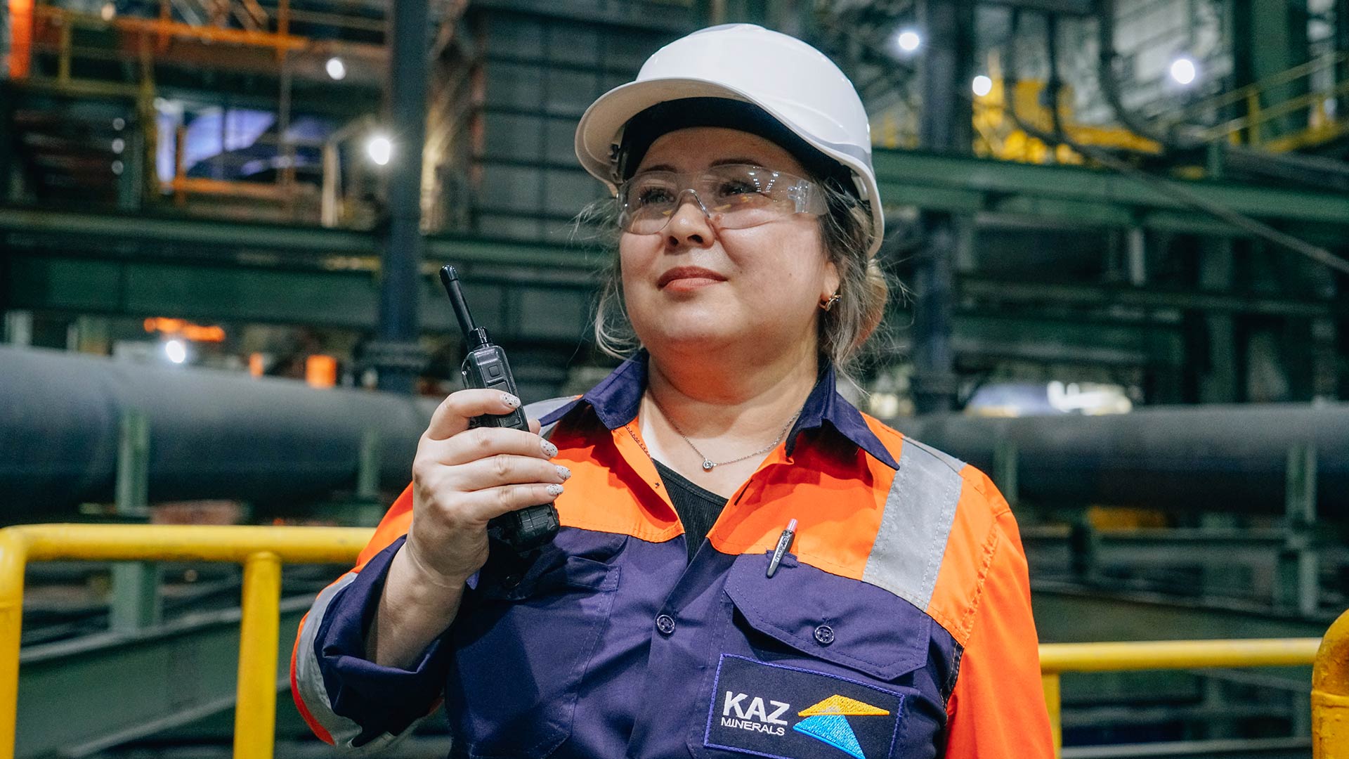 Two workers in safety uniform working together.